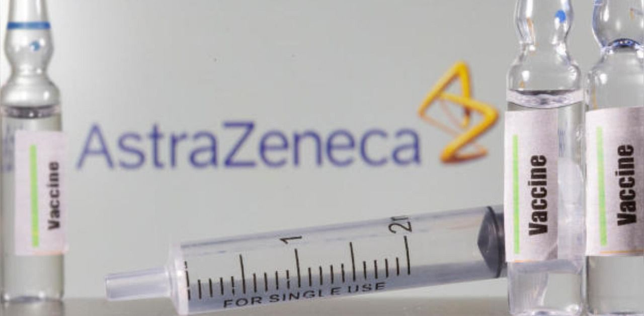 A test tube labelled with the Vaccine is seen in front of AstraZeneca logo. Credit: Reuters Photo