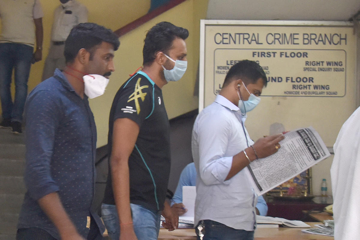 Malleswaram jeweller Vaibhav Jain (in T-shirt) at the CCB office in Bengaluru after his arrest in the drugs case on Saturday. DH PHOTO/S K DINESH