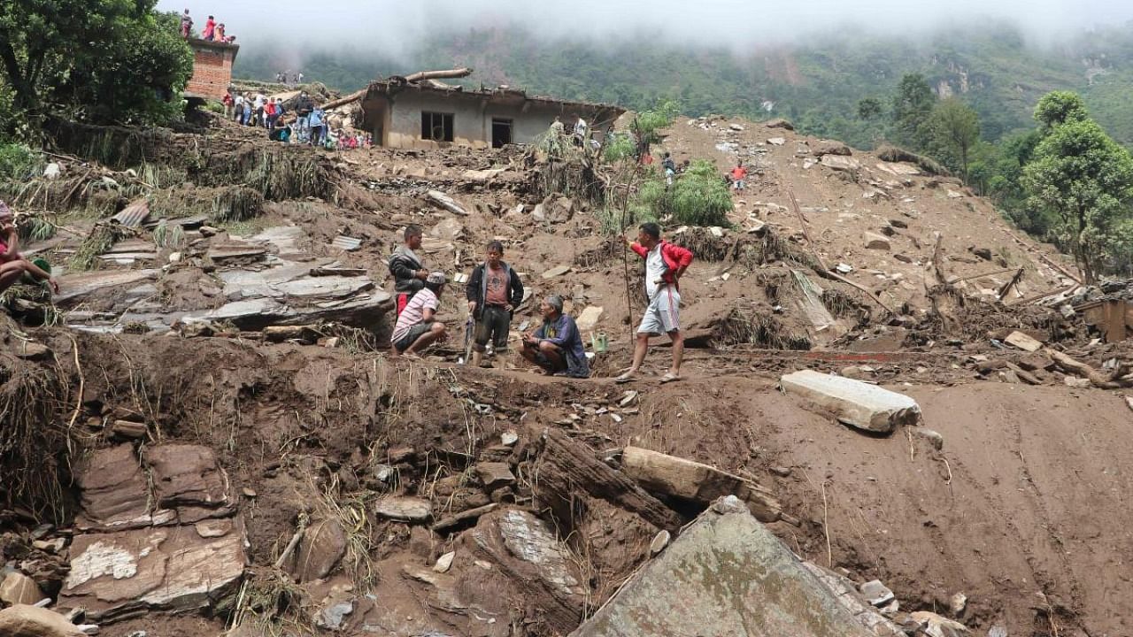 Residents and rescue workers search for bodies of landslides victims, following heavy rains in Bahrabise municipality of Sindhupalchok district, some 90 km northeast of Kathmandu. Credit: AFP