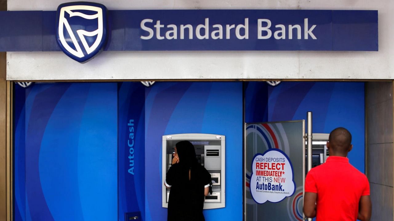 Customers queue to draw money from an ATM outside a branch of South Africa's Standard Bank in Cape Town. Credit: Reuters/file photo