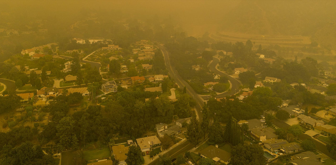 An aerial view shows neighborhoods enshrouded in smoke as the Bobcat Fire advances toward foothill cities and new evacuation order go into effect on September 13, 2020 in Monrovia, California. Credit: AFP Photo