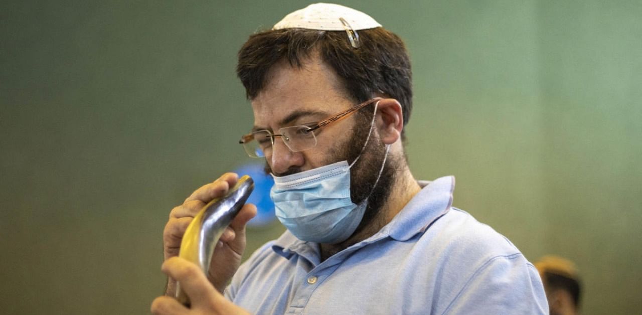A person examines a shofar, a musical instrument made from an animal horn, during a shofar blowing course ahead of the Jewish New Year in Tel Aviv, Israel. Credit: AP/PTI