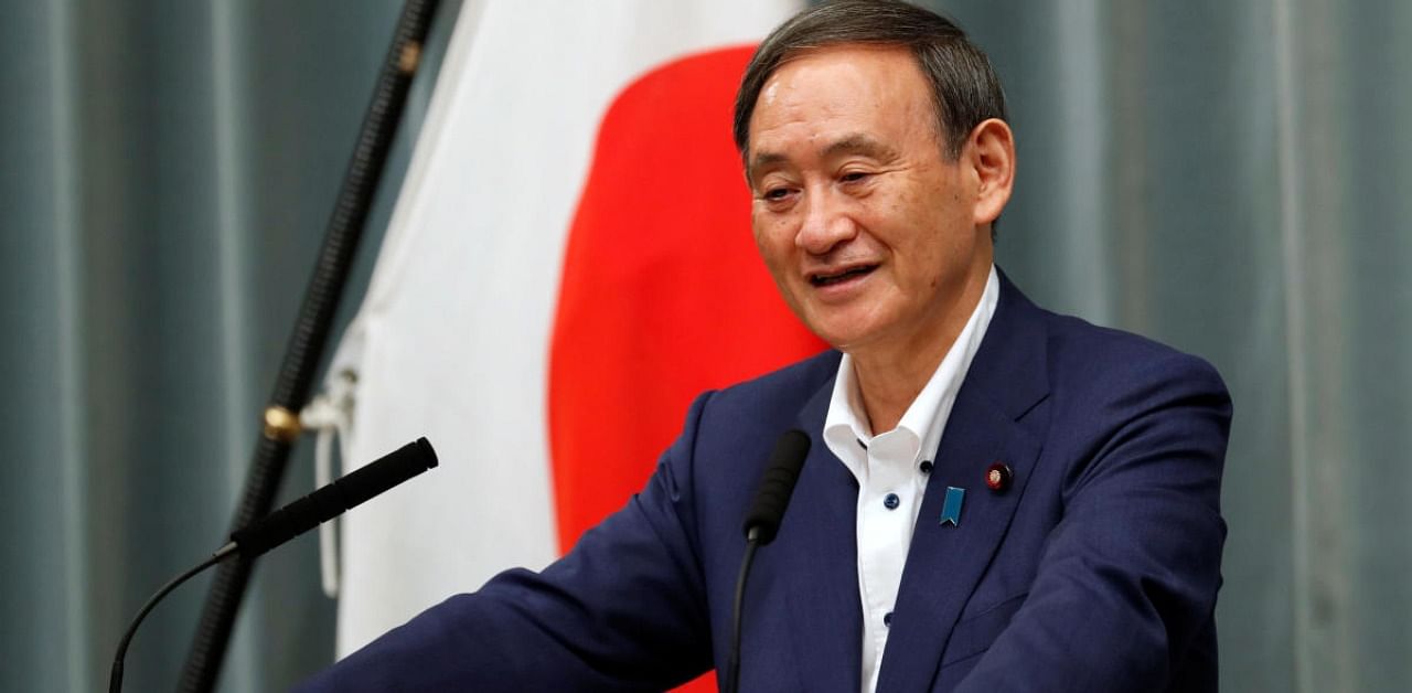 Japan's Chief Cabinet Secretary Yoshihide Suga smiles during his regular news conference at the Prime Minister's official residence in Tokyo, Japan. Credit: Reuters