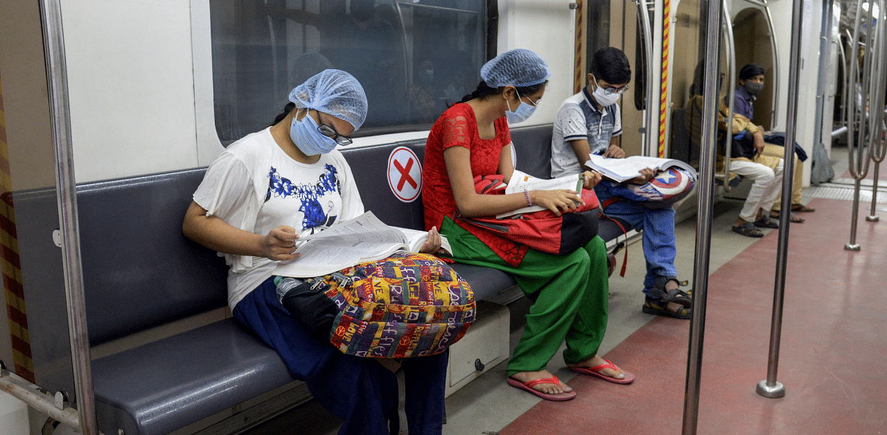 Candidates appearing in the NEET travel in a Kolkata metro train. Credit: PTI Photo