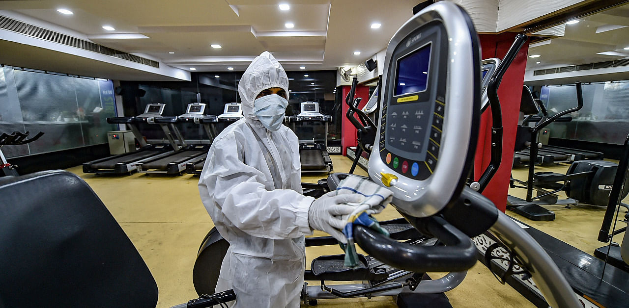 Staff cleans gym equipment in Delhi. Credit: PTI Photo