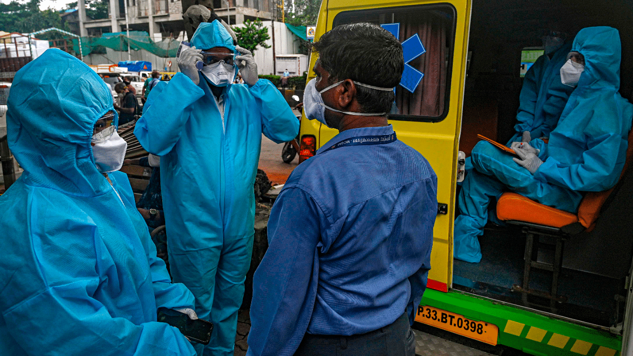 Health workers wearing Personal Protective Equipment (PPE) get ready to conduct a Covid-19. Credits: AFP Photo