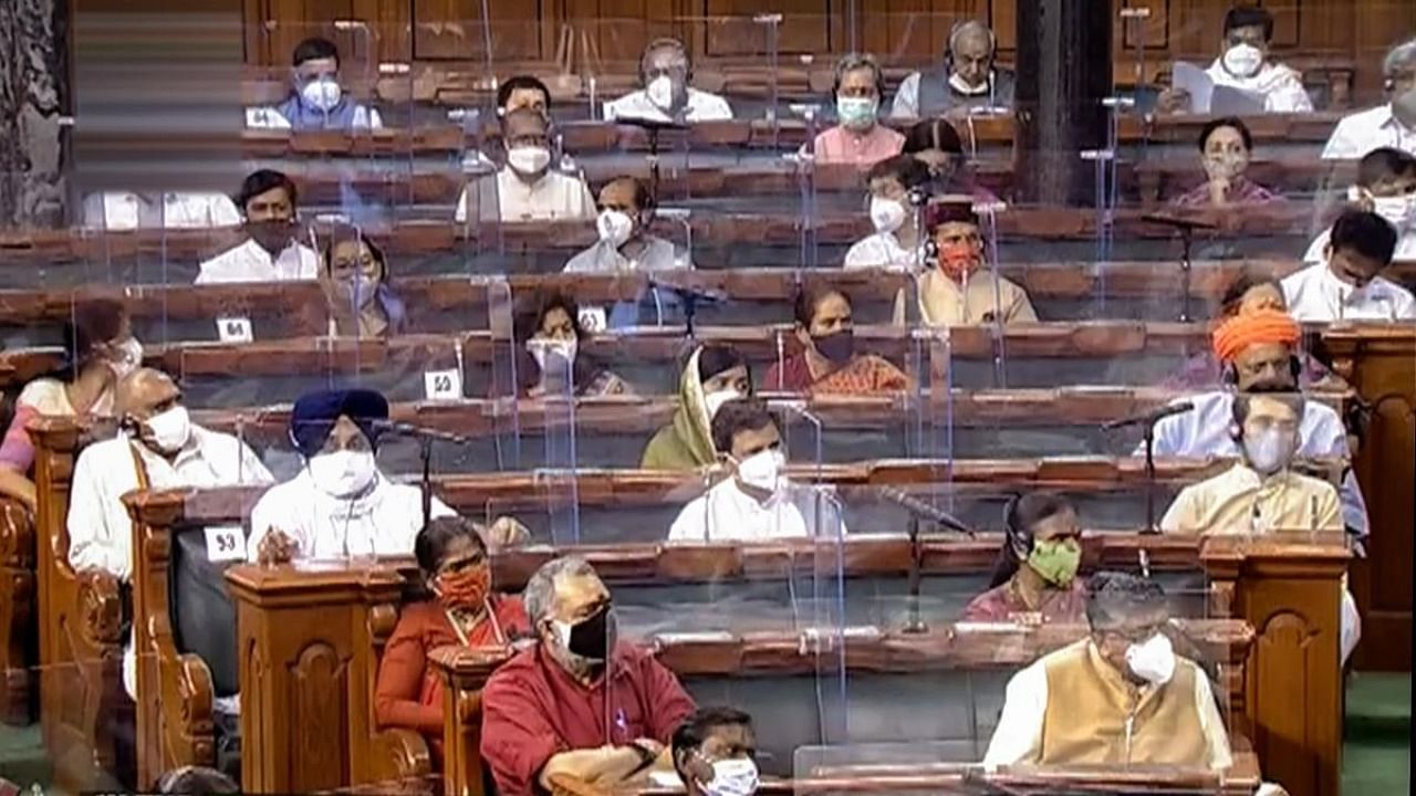 Parliamentarians in the Lok Sabha attend the ongoing Monsoon Session of Parliament, amid the ongoing coronavirus pandemic, in New Delhi. Credit: PTI