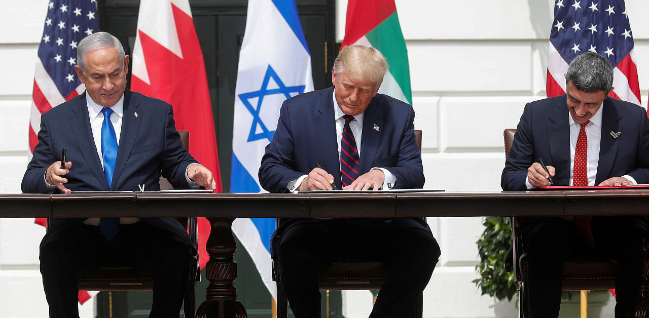 Israel's Prime Minister Benjamin Netanyahu, U.S. President Donald Trump and United Arab Emirates (UAE) Foreign Minister Abdullah bin Zayed sign the Abraham Accords, normalizing relations between Israel and some of its Middle East neighbors. Credit: Reuters Photo