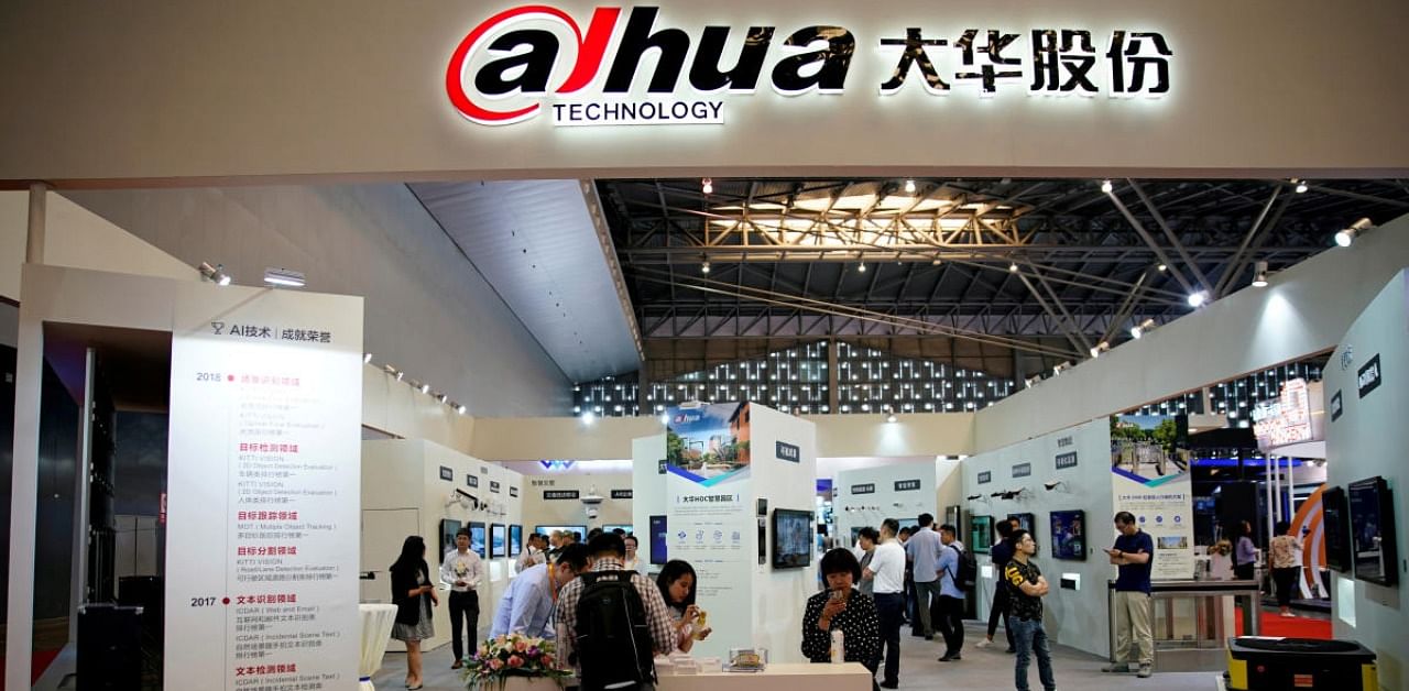 People visit a Dahua Technology booth at a security exhibition in Shanghai, China. Credit: Reuters
