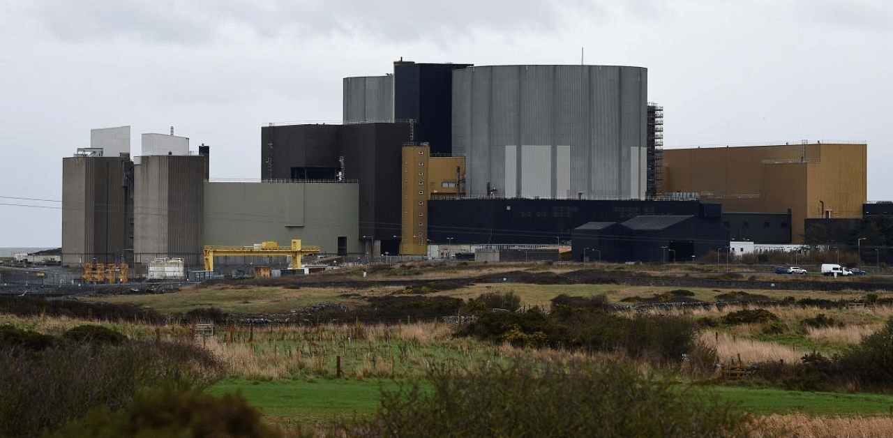 Wylfa Newydd nuclear power station beyond a farmer's field in Anglesey in northwest Wales. - Hitachi said it is pulling out of a multi-billion-pound nuclear power plant project in Wales, citing a worsening investment environment. Credit: AFP Photo