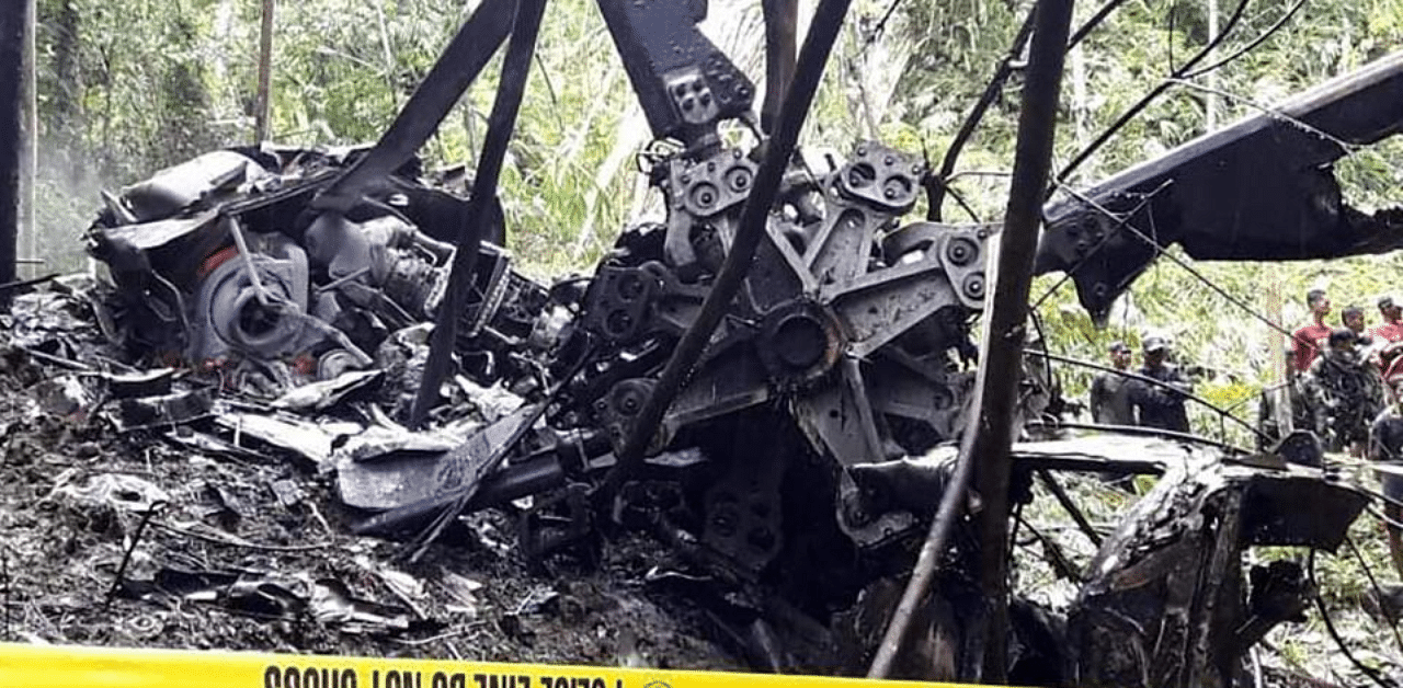 Rescuers check the remains of a Philippine air force S-76A Sikorsky helicopter after it crashed. Credit: AP