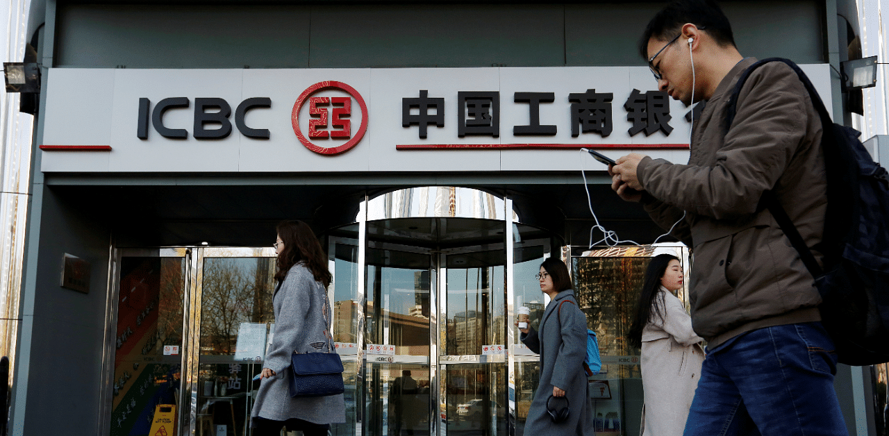 People walk past a branch of Industrial and Commercial Bank of China (ICBC) in Beijing, China. Credit: Reuters Photo