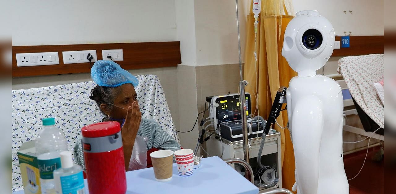 A patient suffering from the coronavirus disease (COVID-19) speaks to his family members, using a robot named 'Mitra' at the Intensive Care Unit (ICU) of the Yatharth Super Speciality Hospital in Noida, on the outskirts of New Delhi, India, September 15, 2020. Credit: Reuters Photo