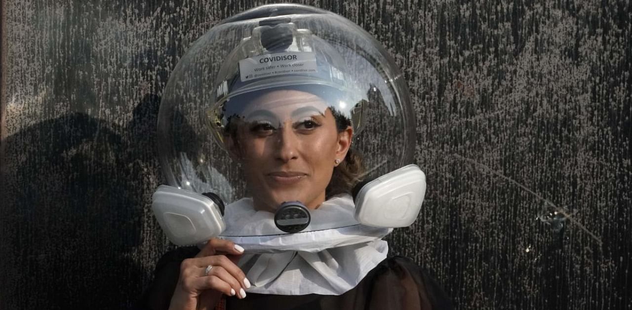 Fashion show attendee Michelle Madonna wears a N95 protection covering called a "Covidisor" before the start of a show during the New York Fashion Week (NYFW). Credit: AFP