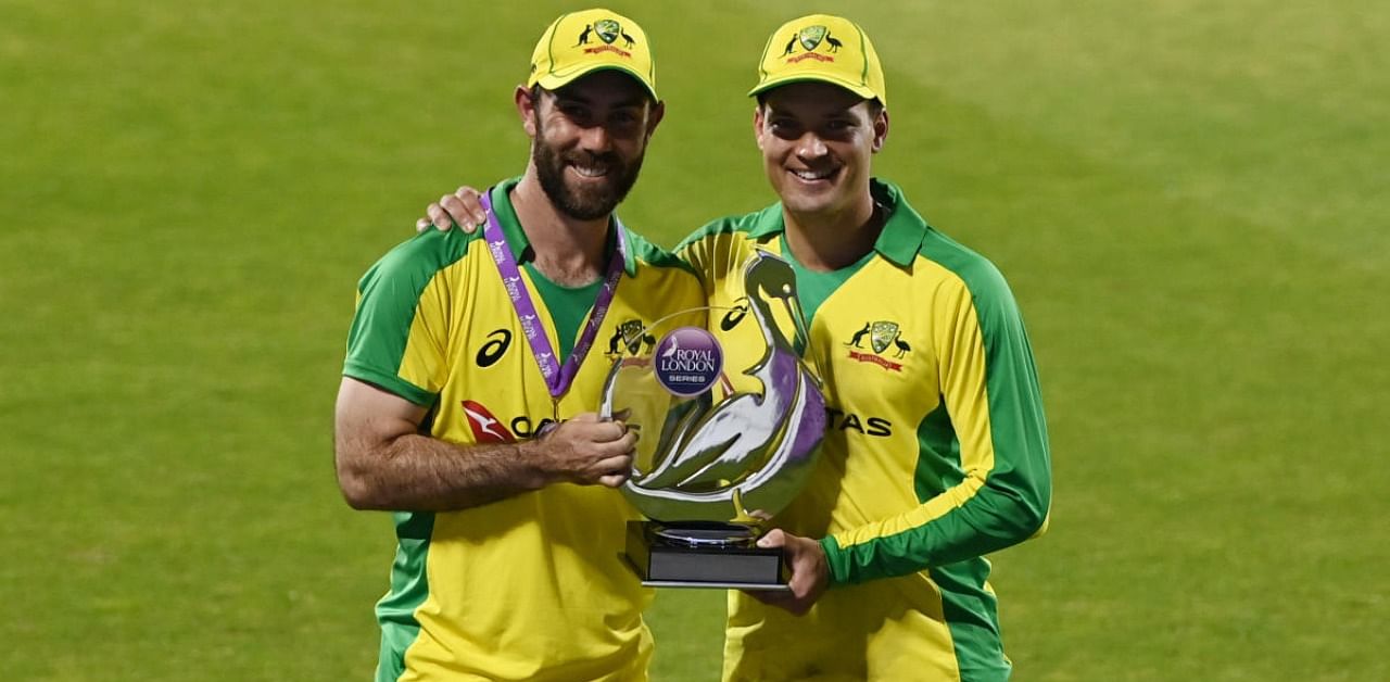 Australia's Glenn Maxwell and Alex Carey pose with the trophy after winning the match and the series Pool. Credit: Reuters