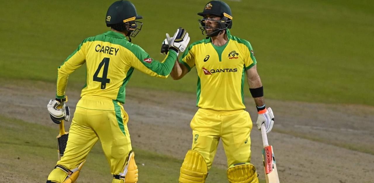 Australia's Glenn Maxwell congratulates teammate Alex Carey after he scored a century during the one-day international (ODI) cricket match between England and Australia. Credit: AFP