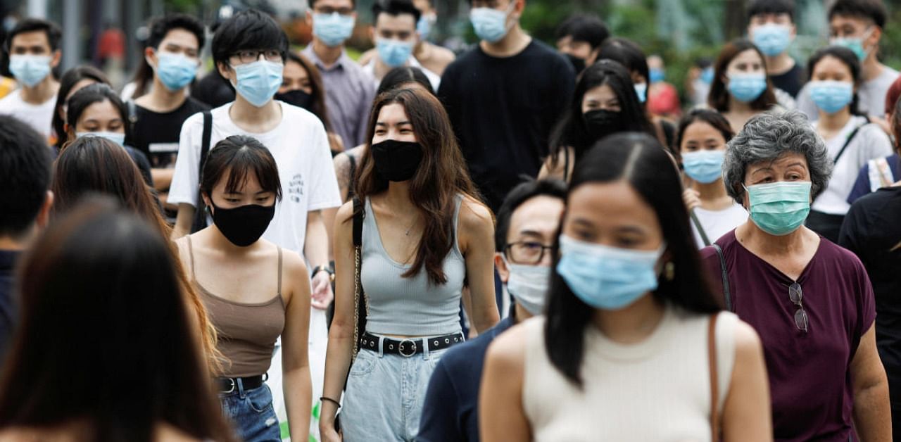 People cross a street at the shopping district of Orchard Road amid the coronavirus outbreak in Singapore. Credit: Reuters