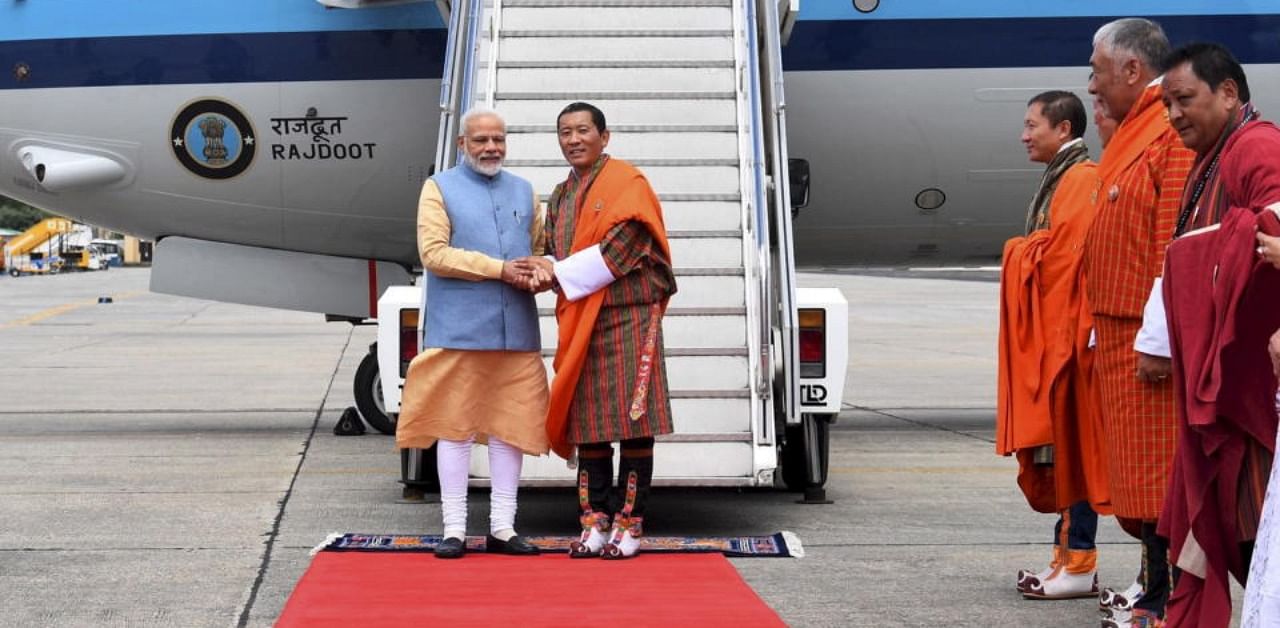 Prime Minister Narendra Modi being welcomed by his Bhutanese counterpart Lotay Tshering on his arrival at Paro International Airport. Credit: PTI