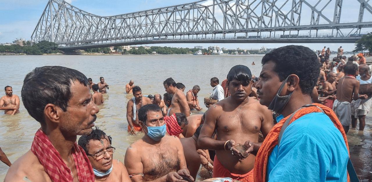 Devotees perform 'Tarpan' ritual on the bank of Ganga river on the occasion of Mahalaya, in Kolkata. Credit: PTI Photo