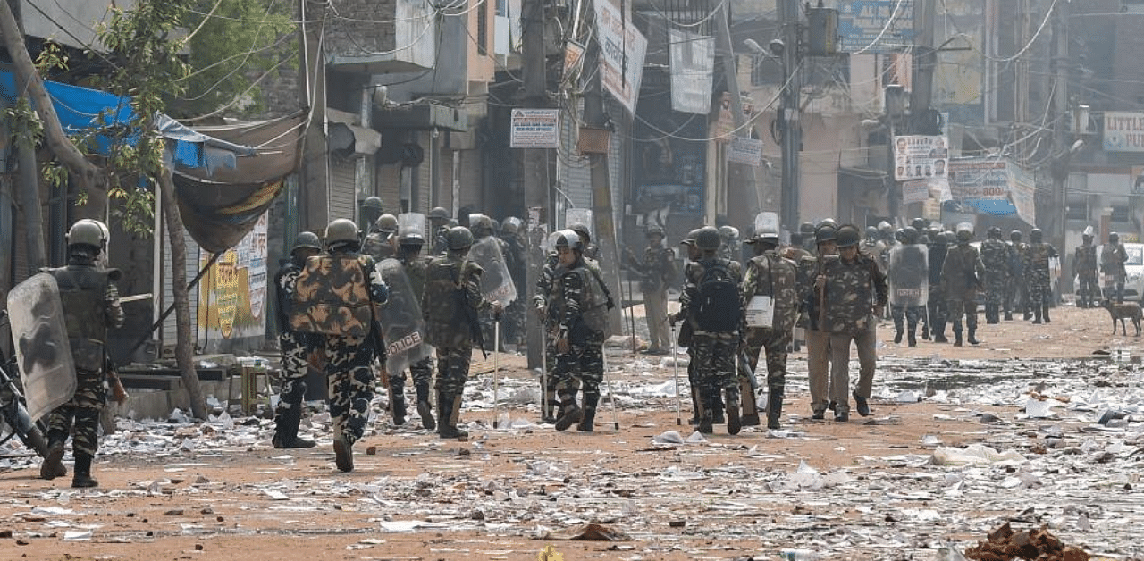 Security personnel conduct patrolling as they walk past Bhagirathi Vihar area of the riot-affected north east Delhi, Wednesday, Feb. 26, 2020. Credit: PTI Photo
