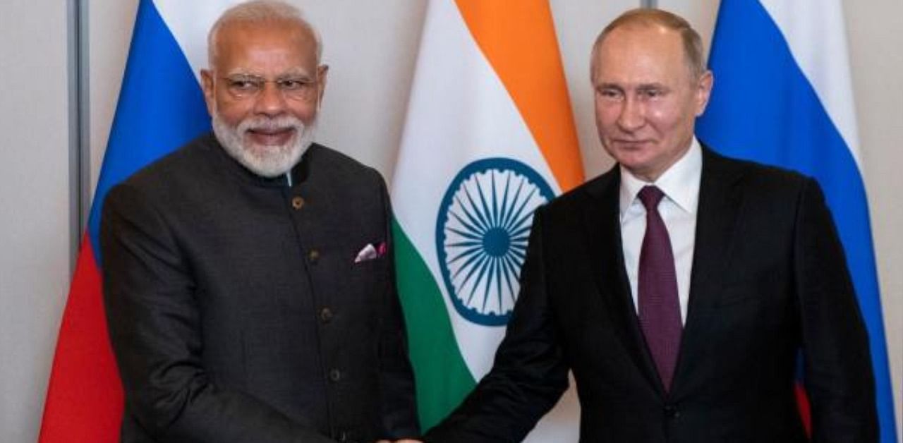 Russian President Vladimir Putin (R) and Indian Prime Minister Narendra Modi shake hands during their meeting on the sidelines of the 11th edition of the BRICS Summit, in Brasilia, Brazil. Credit: AFP Photo