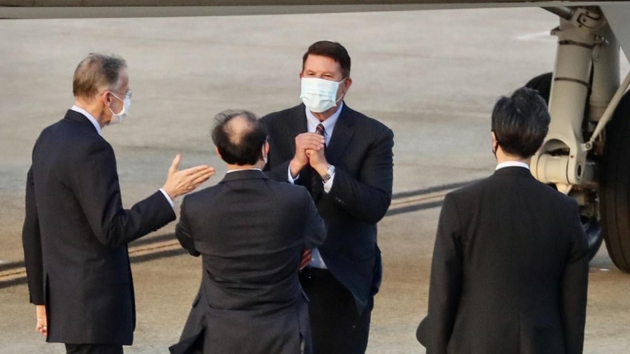 Keith Krach (top C), US Undersecretary of State for Economic Growth, Energy and the Environment, gestures after landing at the Sungshan airport in Taipei. Credit: AFP