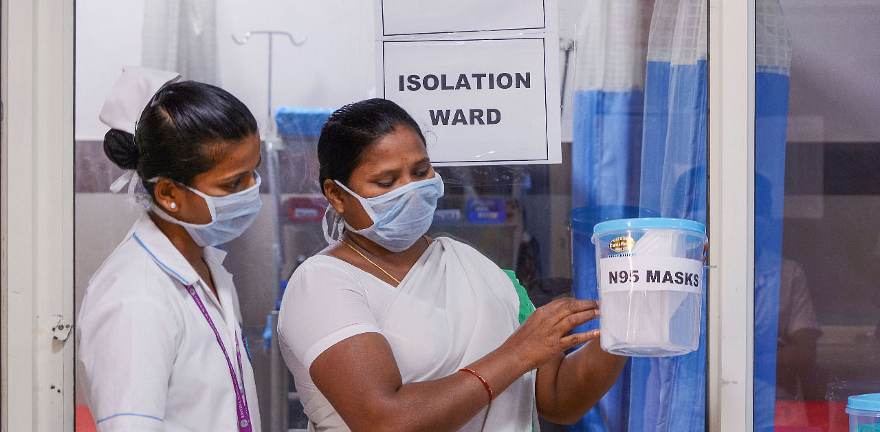 Nurses look at N95 masks inside a Coronavirus ward at a government hospital in Vijayawada. Credit: PTI Photo