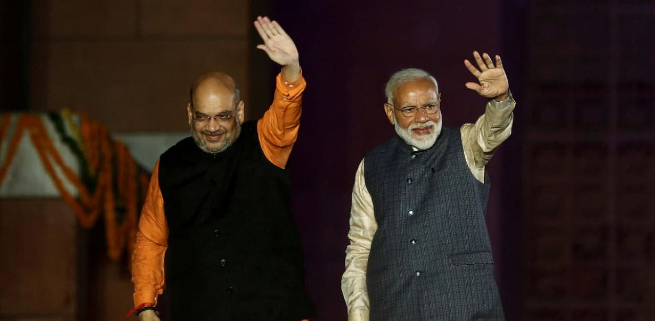Indian Prime Minister Narendra Modi and Bharatiya Janata Party (BJP) President Amit Shah wave towards their supporters. Credit: Reuters