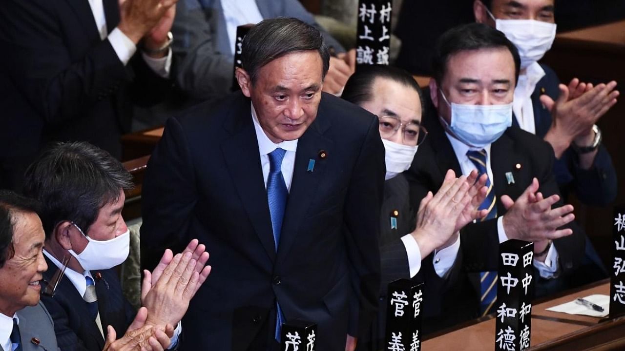 Newly elected leader of Japan's Liberal Democratic Party (LDP) Yoshihide Suga (C) is applauded after he was elected as Japan's prime minister by the Lower House of parliament in Tokyo. Credit: AFP