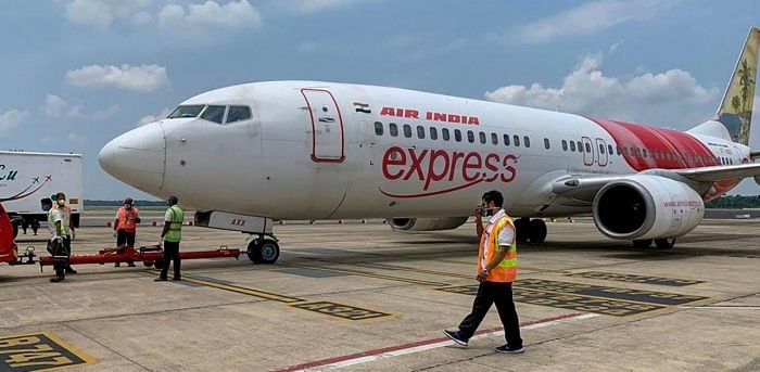 Airport staff carry out pre-departure checking of an Air India Express flight bound for UAE to bring back stranded Indian nationals. Credit: PTI.