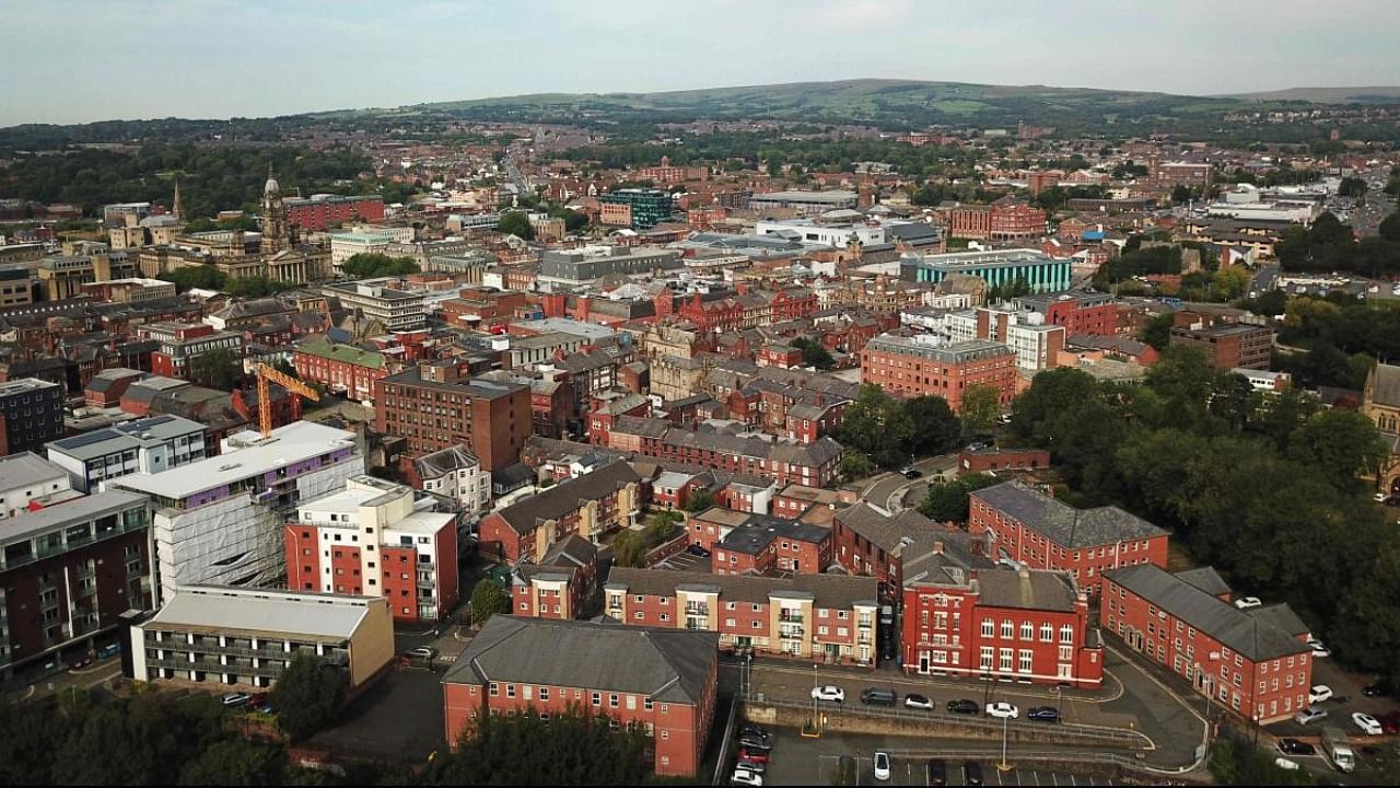 An aerial view shows the city of Bolton, northern England on September 15, 2020, as local lockdown restrictions are put in place due to a spike in cases of the novel coronavirus in the city. Credit: AFP.