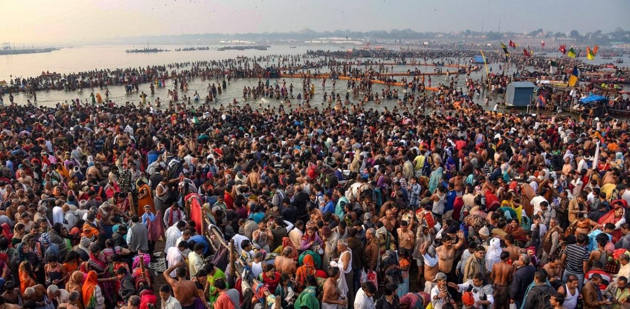 Devotees offer prayer and take holy dip on the occasion of 'Maha Shivaratri' festival during the ongoing Kumbh Mela. Credit: PTI