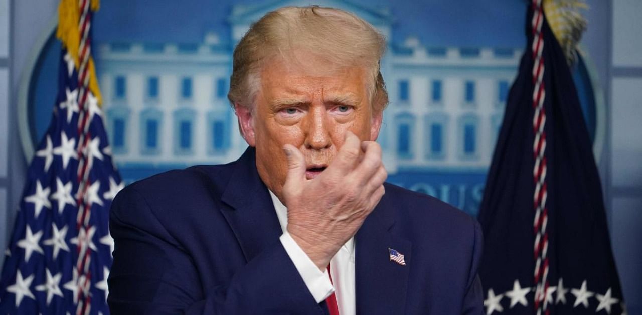 US President Donald Trump gestures as he speaks about masks during a press conference. Credit: AFP