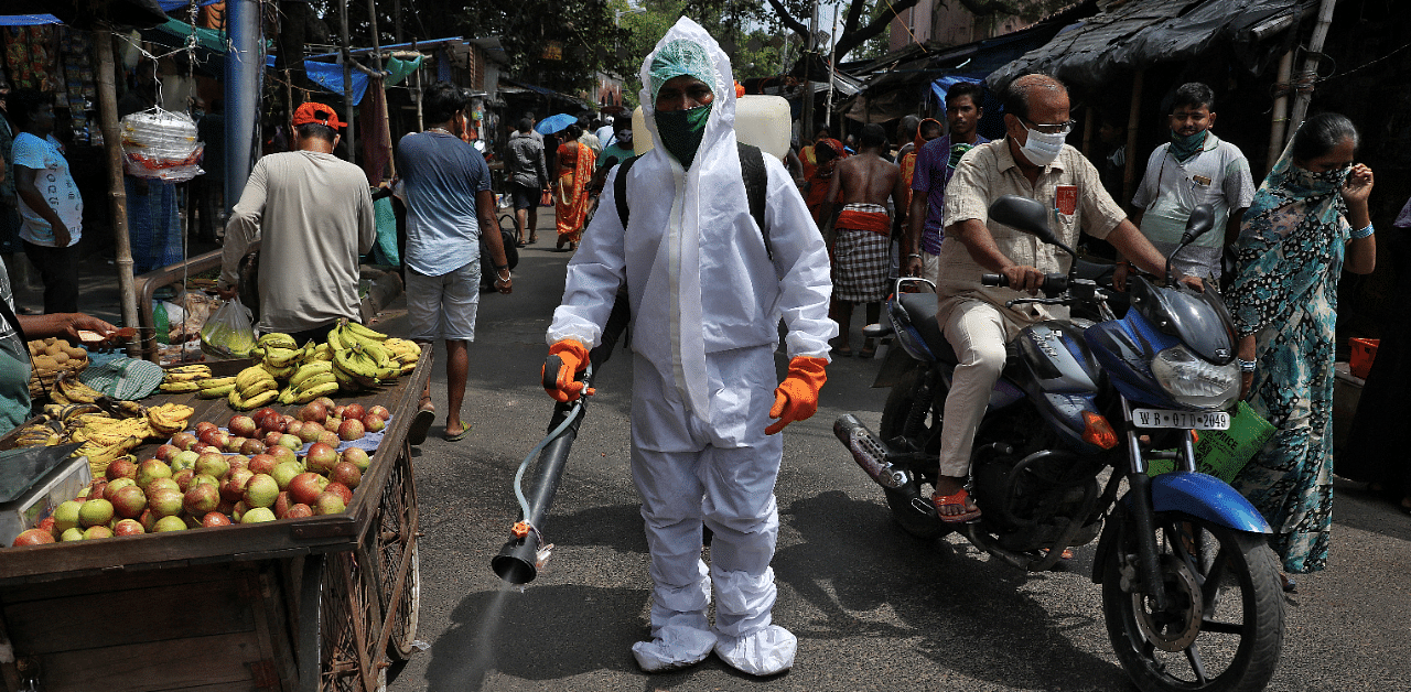 A municipal worker sprays disinfectant to sanitize a street amidst the spread of the coronavirus disease. Credit: Reuters Photo