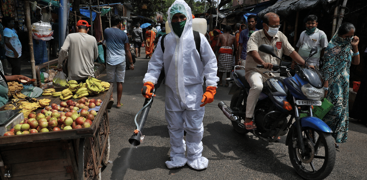 A municipal worker sprays disinfectant to sanitize a street amidst the spread of the coronavirus disease. Credits: Reuters Photo