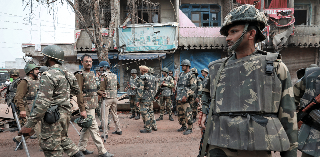 Police stand guard in a riot affected area following clashes between people demonstrating for and against a new citizenship law in New Delhi, February 28, 2020. Credit: Reuters Photo
