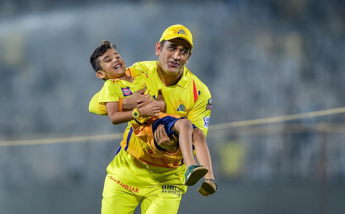 CSK skipper MS Dhoni playing with a son of his teammate Imran Tahir after the Indian Premier League 2019 (IPL T20) cricket match between Chennai Super Kings (CSK) and Kings XI Punjab (KXIP) at MAC Stadium in Chennai, Saturday, April 6, 2019. (PTI Photo)