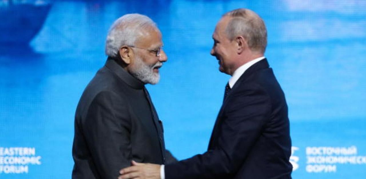 Indian Prime Minister Narendra Modi (L) shakes hands with Russian President Vladimir Putin. Credit: PTI Photo