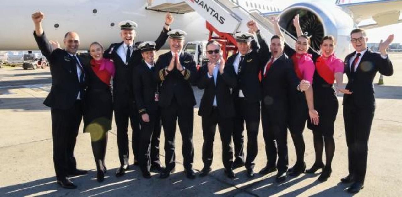 Qantas Group CEO Alan Joyce (C) and crew in front of a Qantas Boeing 787 Dreamliner plane. Credit: AFP Photo