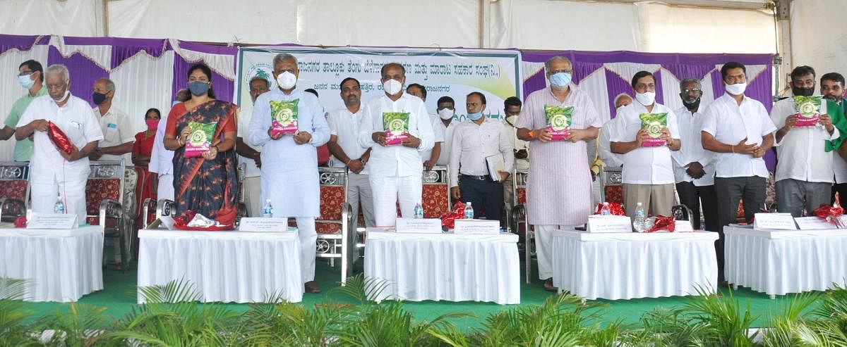Ministers S T Somashekar, S Suresh Kumar and other dignitaries release the coconut byproduct, at Munachanahalli in Chamarajanagar taluk on Friday. DH PHOTO