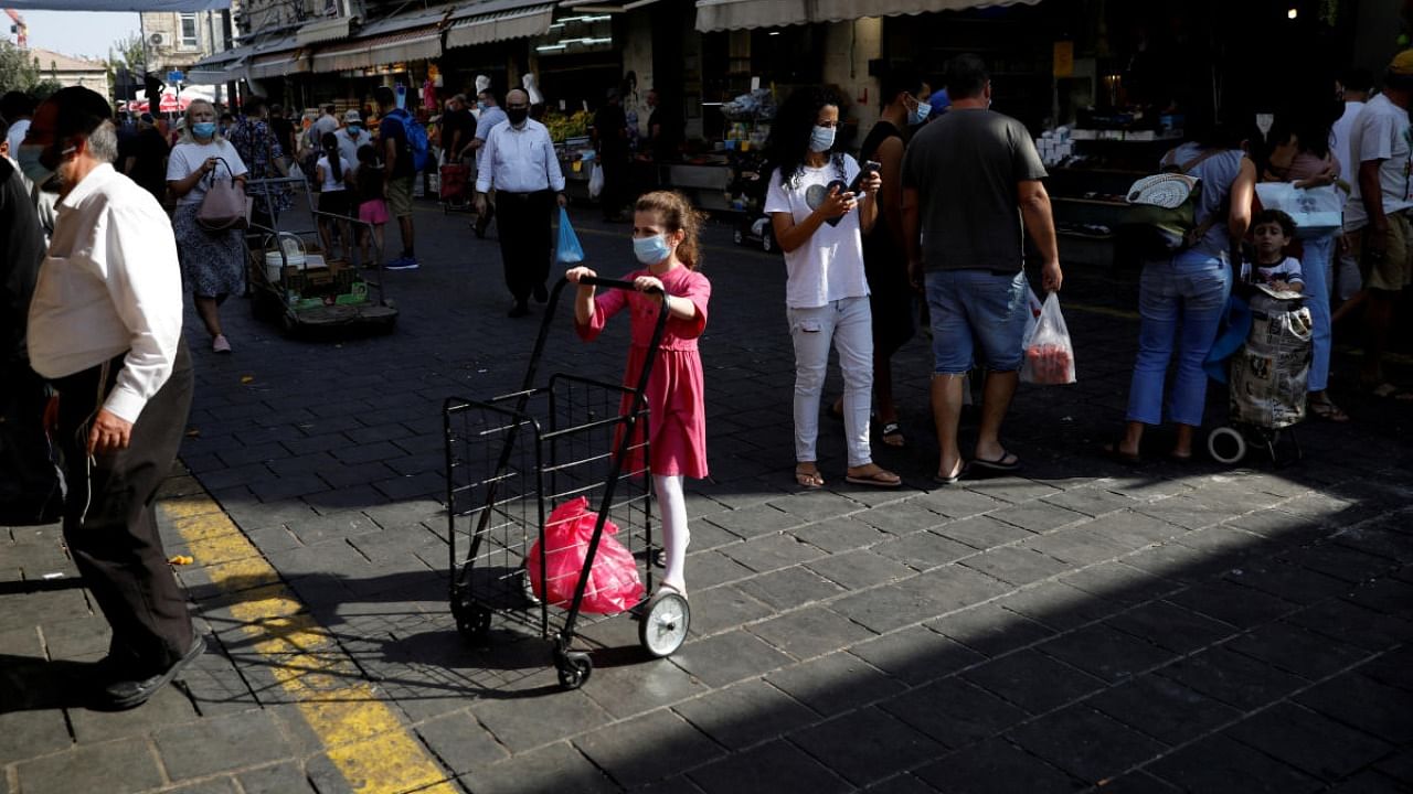 Israelis shop at the main market before Israel will enter a second nationwide lockdown amid a resurgence in new coronavirus cases, forcing residents to stay mostly at home during the Jewish high-holiday season, in Jerusalem. Credit: Reuters.