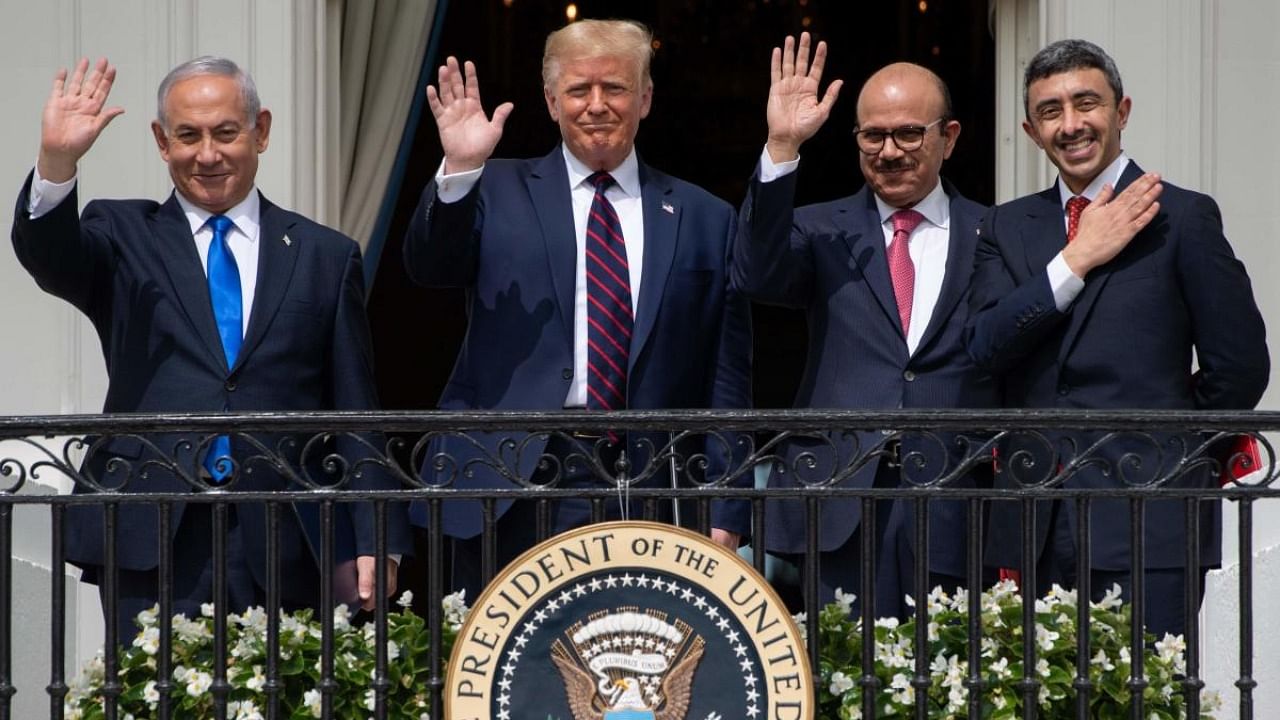 (L-R)Israeli Prime Minister Benjamin Netanyahu, US President Donald Trump, Bahrain Foreign Minister Abdullatif al-Zayani, and UAE Foreign Minister Abdullah bin Zayed Al-Nahyan wave from the Truman Balcony at the White House after they participated in the signing of the Abraham Accords where the countries of Bahrain and the United Arab Emirates recognise Israel. Credit: AFP.
