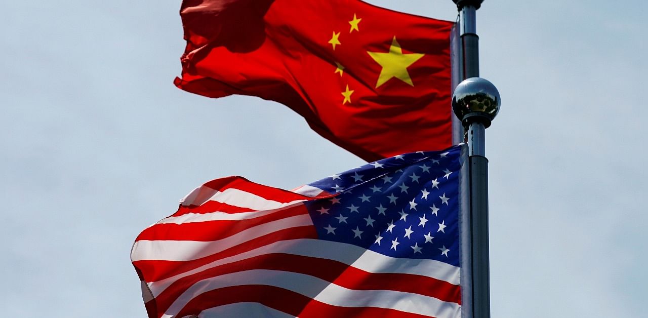 Chinese and US flags flutter near The Bund. Credit: Reuters