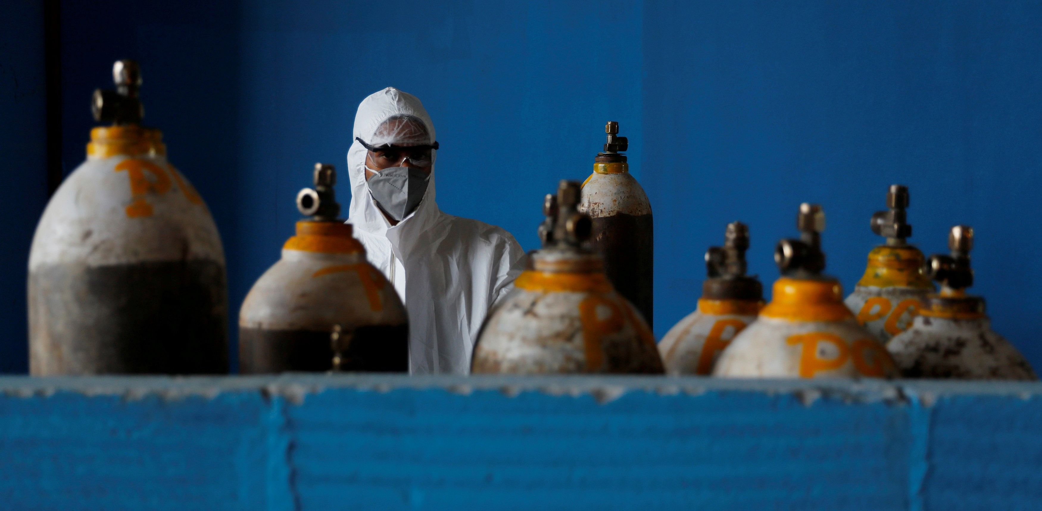 A medical worker stands next to an oxygen cylinder at the Yatharth Hospital in Noida. Credit: Reuters