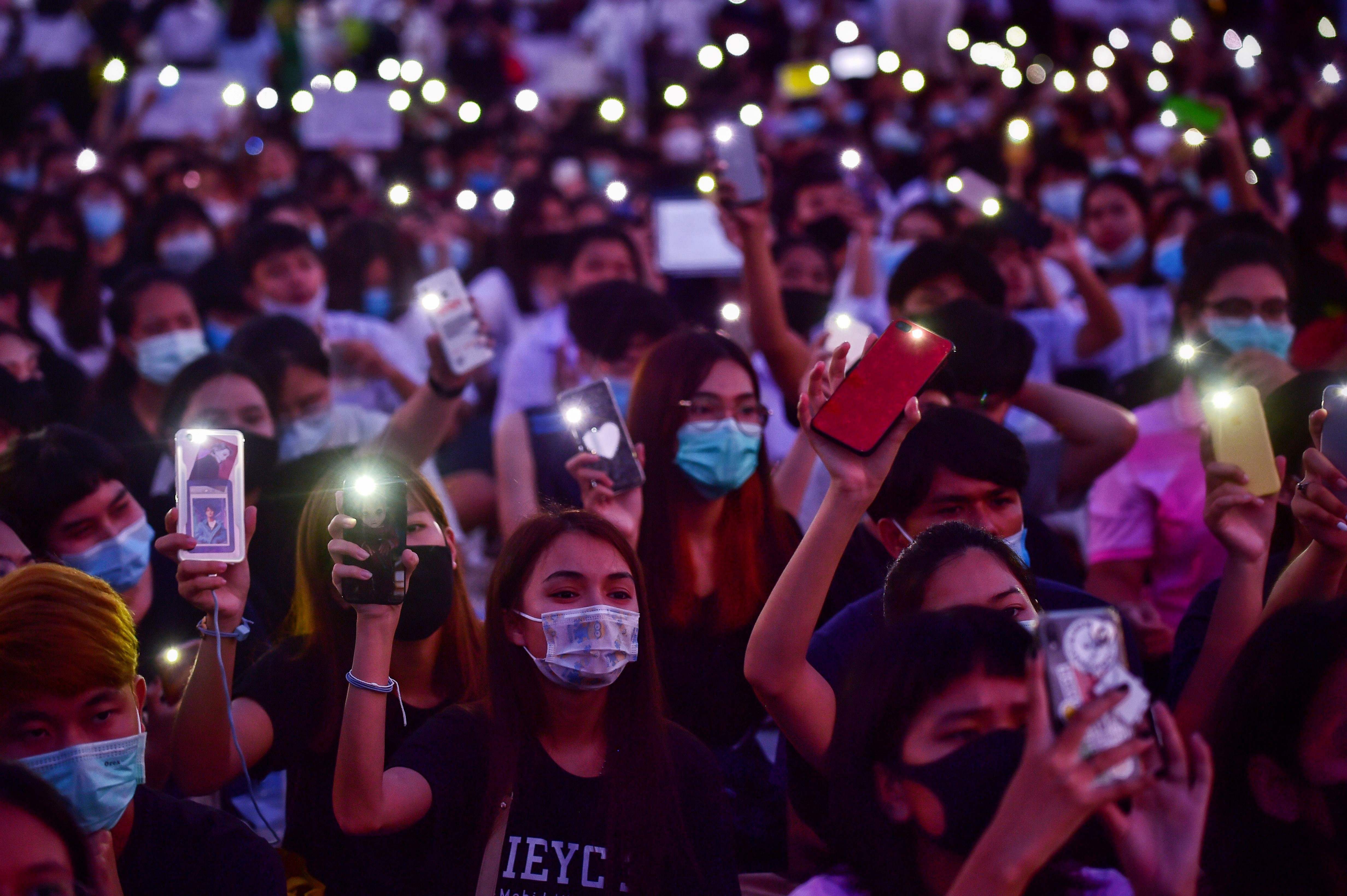 Student protesters use their mobile phones as flashlights during an anti-government rally at King Mongkut's Institute of Technology in Bangkok. Credits: AFP Photo
