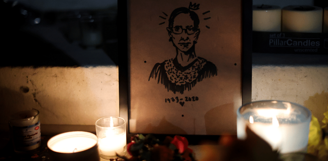 Candles and an image of late US Supreme Court Justice Ruth Bader Ginsburg are seen as people gather in front of the US Supreme Court following her death. Credit: Reuters Photo