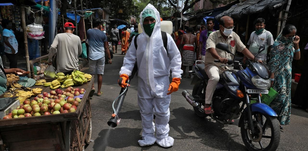 A municipal worker sprays disinfectant to sanitize a street amidst the spread of the coronavirus disease in Kolkata, India. Credit: Reuters