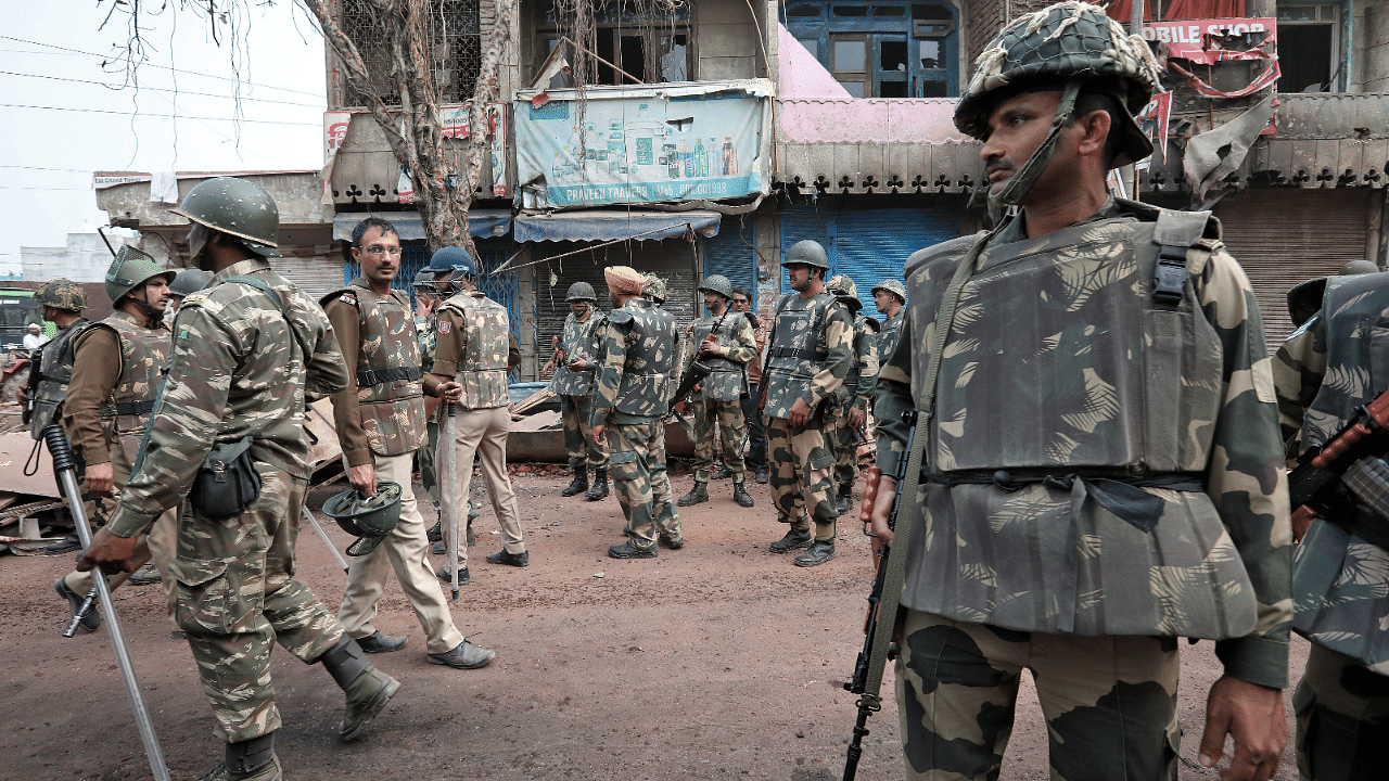 Police stand guard in a riot affected area following clashes between people demonstrating for and against a new citizenship law in New Delhi. Credits: Reuters Photo