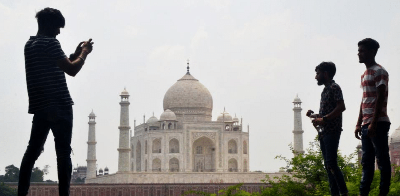 People take pictures with their mobile phones near the Taj Mahal in Agra on September 8, 2020. Credit: AFP Photo