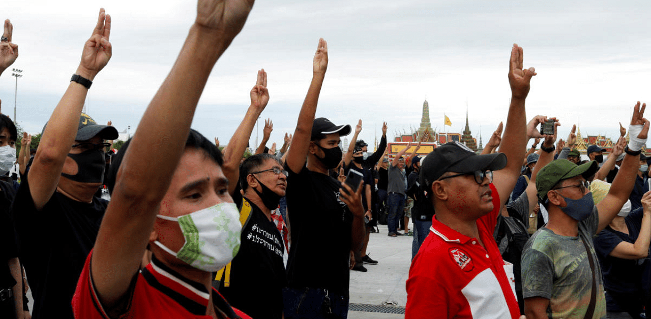 Pro-democracy protesters flashing the three-fingers salute, attend a mass rally to call for the ouster of prime minister Prayuth Chan-ocha's government and reforms in the monarchy, in Bangkok, Thailand. Credit: Reuters Photo